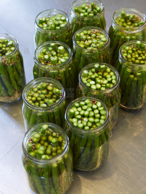 Close up of preserved green asparagus in jars