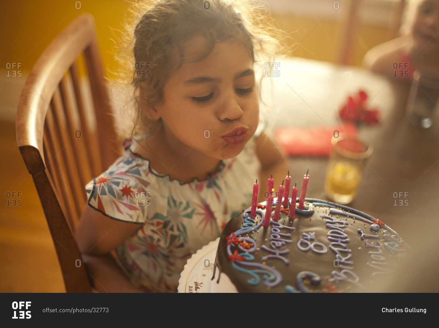 Cute little girl blowing out candles on her birthday cake. stock photo ...