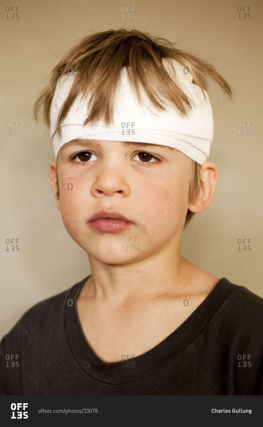 Portrait of boy with head bandage