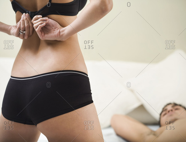 Man unfastening woman's bra Stock Photo