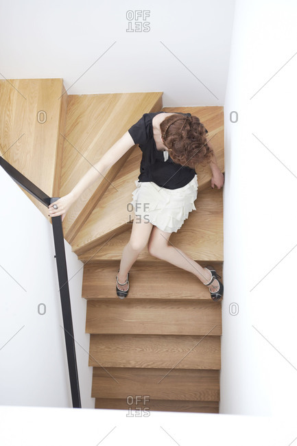 A model sitting on stairs stock photo - OFFSET