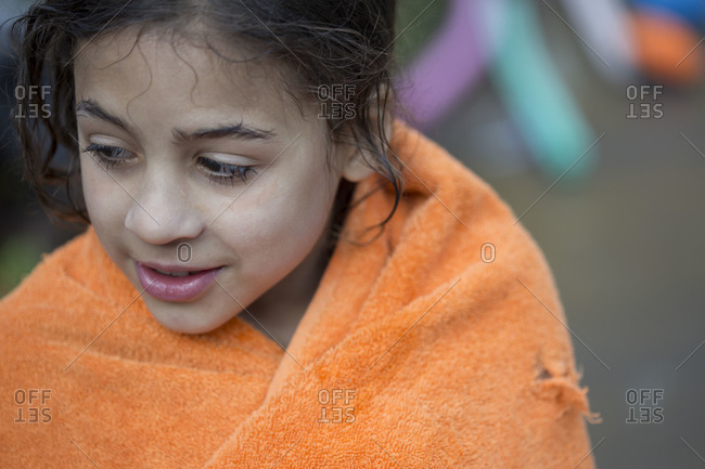 Brunette enchanted wet little girl in towel