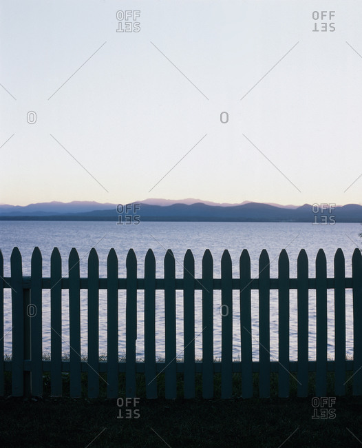 Picket fence at dusk by the shore of Lake Champlain