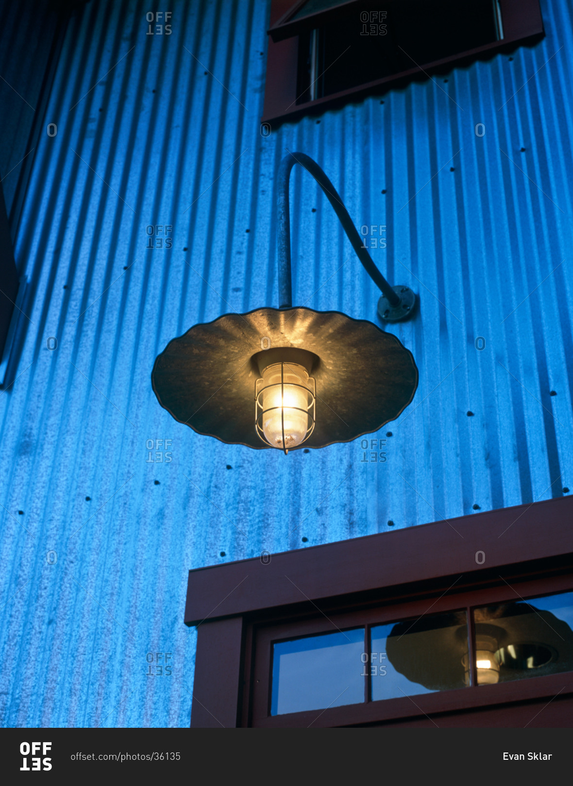 Detail of contemporary country style outdoor light above entrance way at dusk