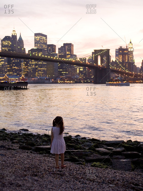 Young Girl Looks at Manhattan at Dusk