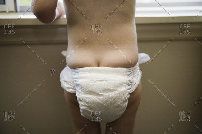 Little girl wearing blue panties with pink hearts stock photo - OFFSET
