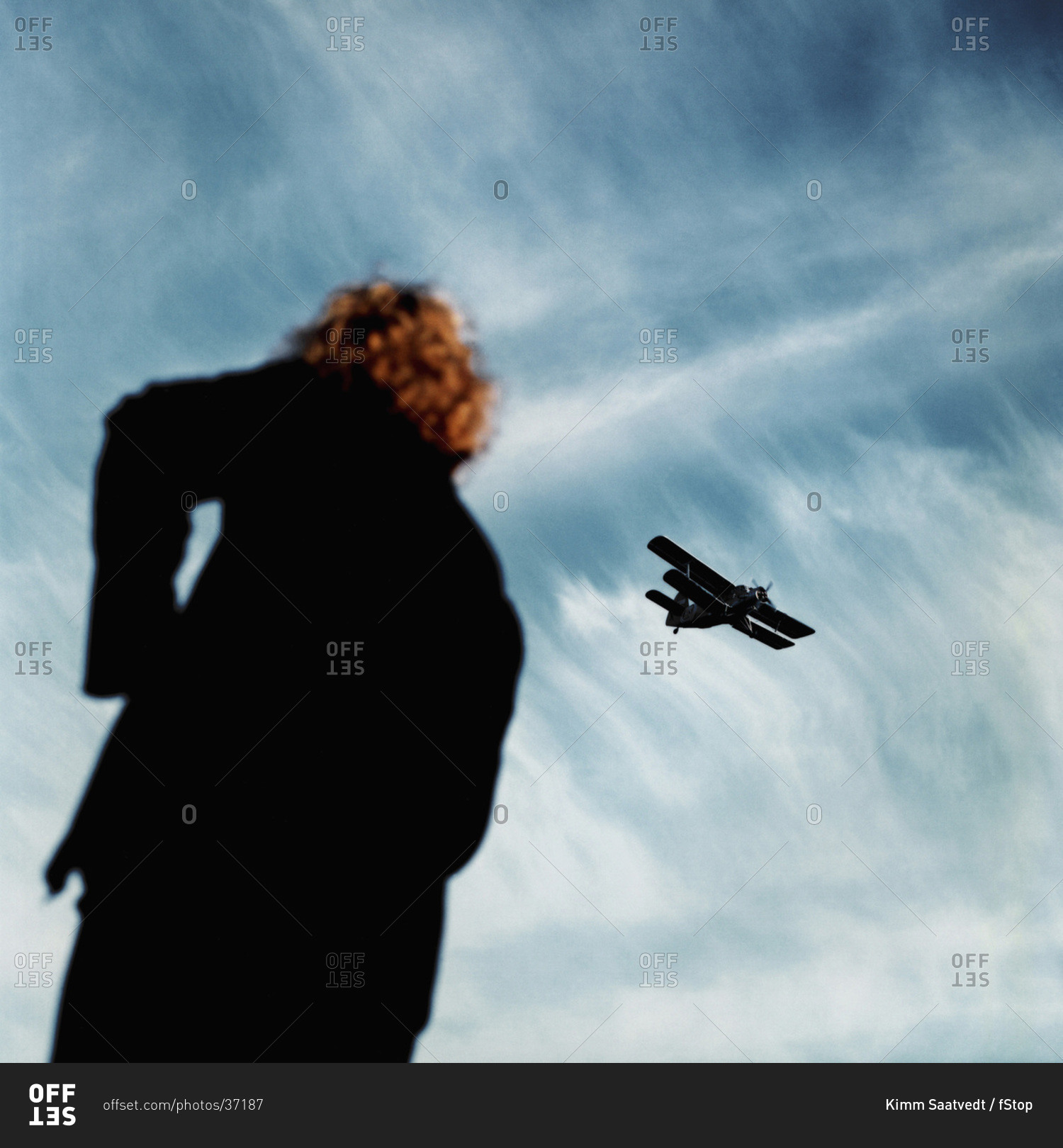 A Person Looking Up In The Sky At An Airplane Stock Photo Offset