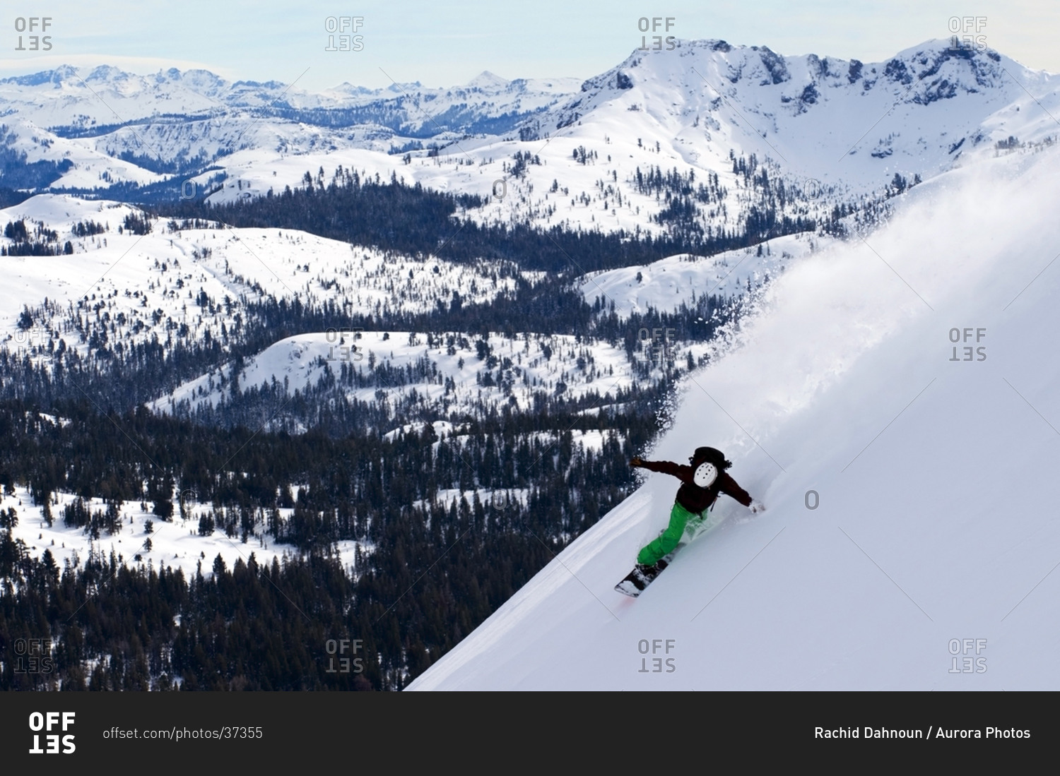 A snowboarder rips a huge turn in deep powder on Red Lake Peak off of Carson Pass near Lake Tahoe, CA.