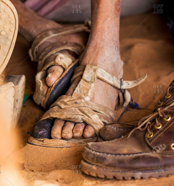 thick beside Write a report Dirty feet in sandals on sandy ground stock photo - OFFSET