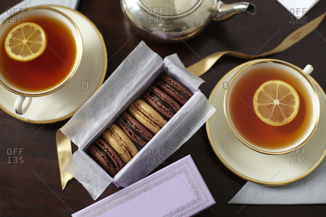 Tea time, French style: two cups of tea served with macaroons