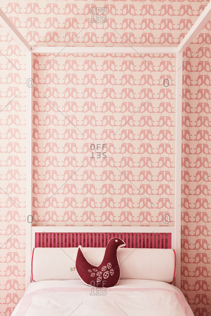 a pink bedroom with bird motif
