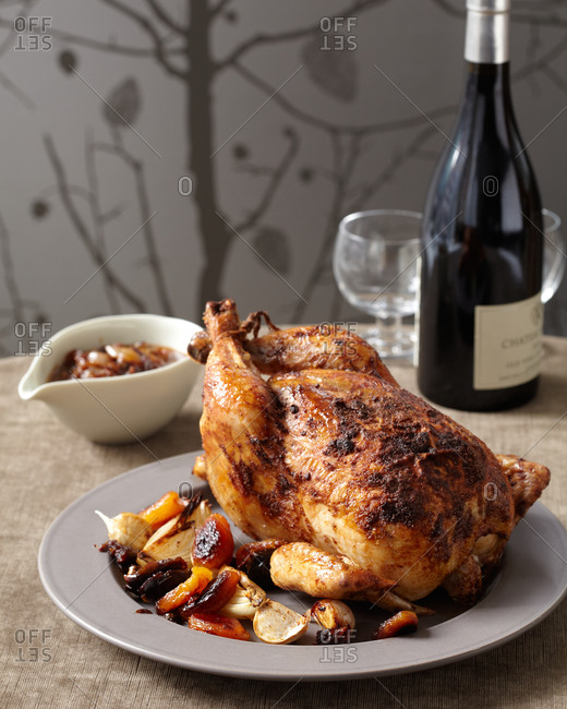 Whole roasted chicken Moroccan style served with vegetables and wine