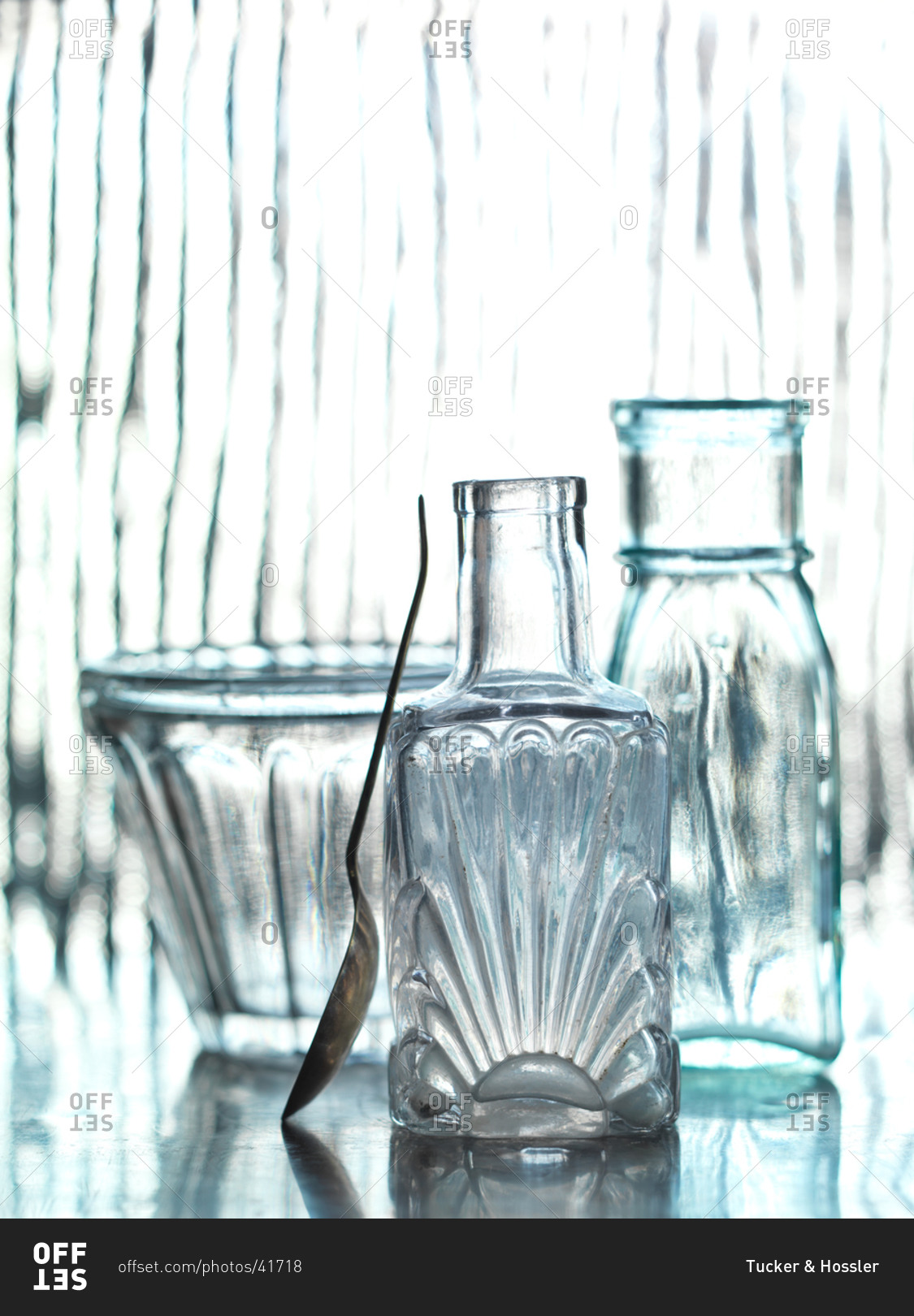 Two bottles and a glass with spoon stock photo OFFSET