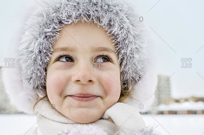Happy young woman in winter clothes in hats outdoors There is a lot of snow  around Stock Photo
