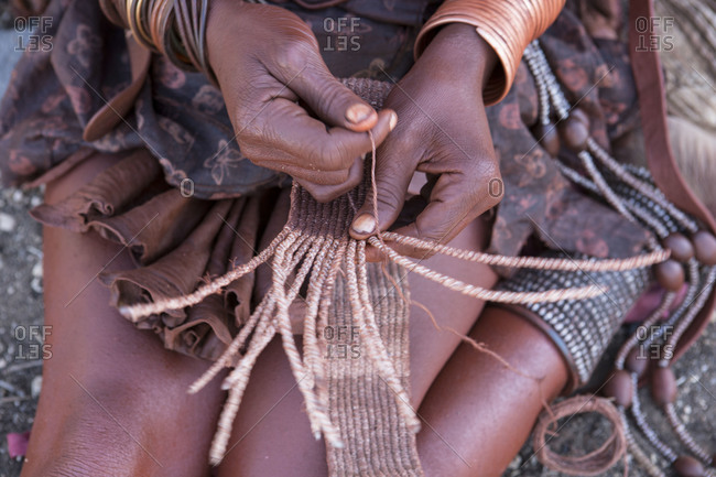 Close-up of Himba woman weaving belt