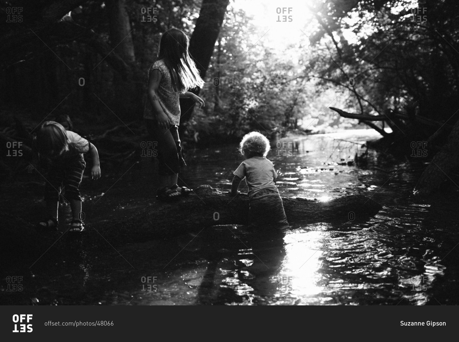 A Group Of Children Play Near A Riverbed Together Stock Photo - Offset