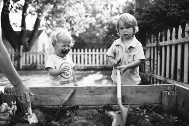 Little boy on the beach throwing stones to the water