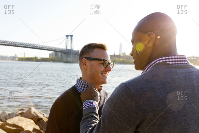 Portrait of gay couple on river bank
