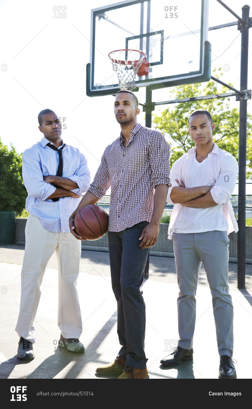 Three african american men in business suit standing on basketball court