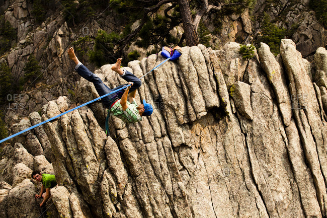 A male highliner falls off the Elephant Buttresses highline in Boulder Canyon, Colorado.