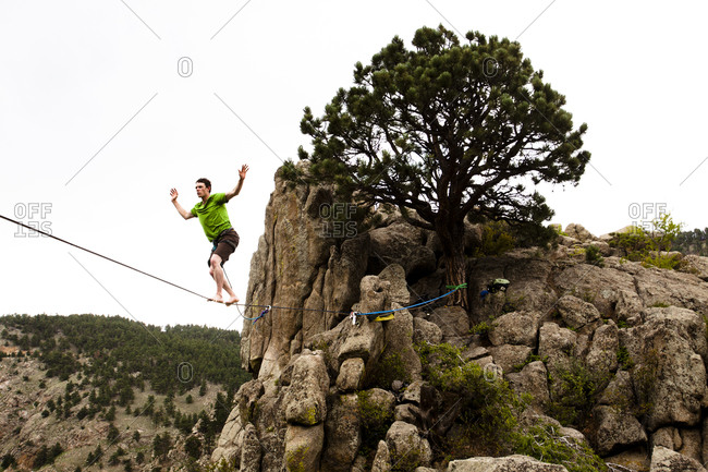 A male highliner walks the Elephant Buttresses highline in Boulder Canyon, Colorado.