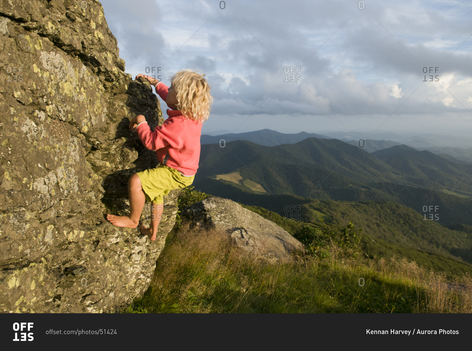 A young girl rock climbing on Grassy Ridge, Bakersville, North Carolina.