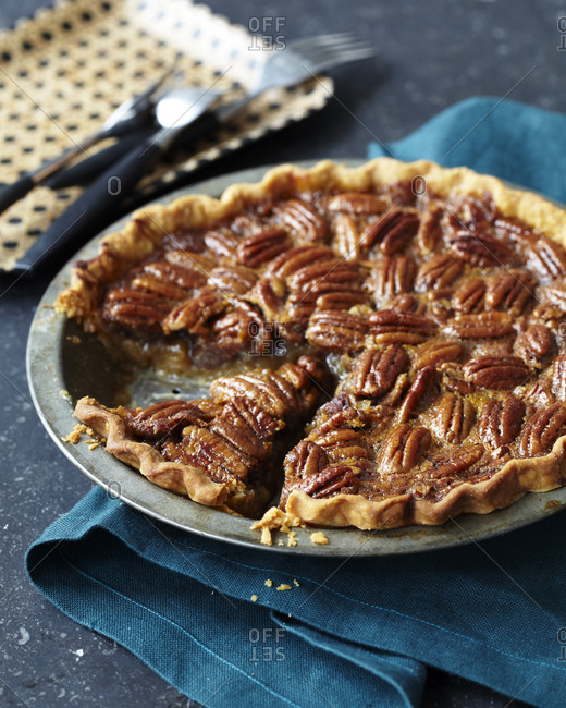 Freshly baked bourbon pecan pie with one slice missing