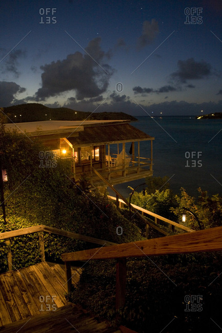 Night view of beachfront cottages and tranquil Atlantic Ocean.