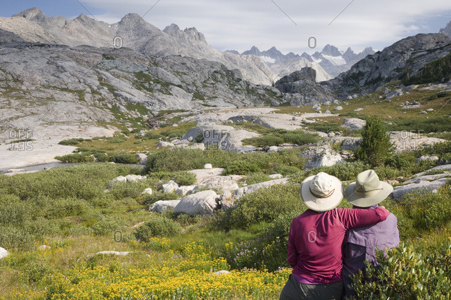 USA,  Wyoming,  Bridger NF,  Bridger Wilderness A couple enjoy the rugged scenery of the Wind River Range and Titcomb Basin