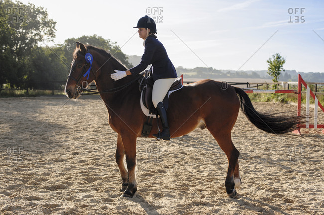 Caucasian girl and horse winning equestrian competition