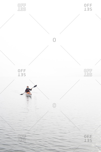 Woman kayaking on the calm water