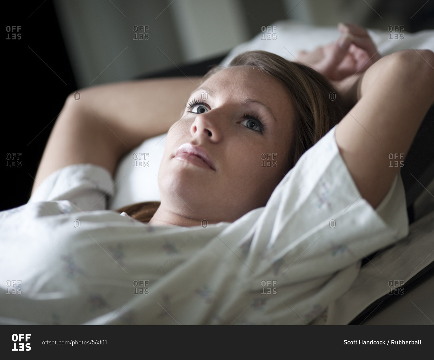 Young woman lying in hospital gown
