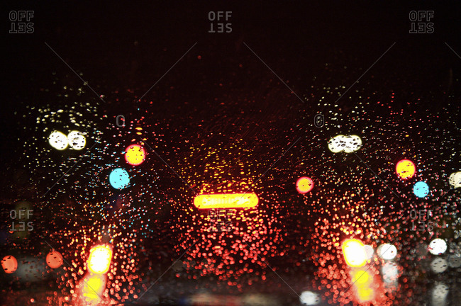 Car and streetlights through a wet windscreen