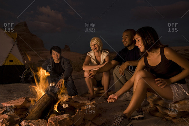 People sitting around a campfire at night