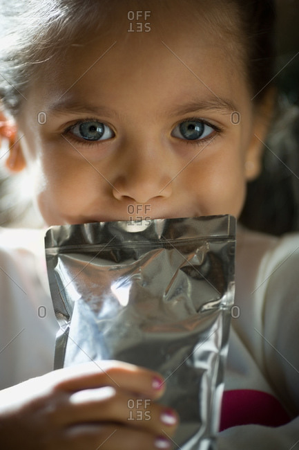 Girl drinking from a juice pack