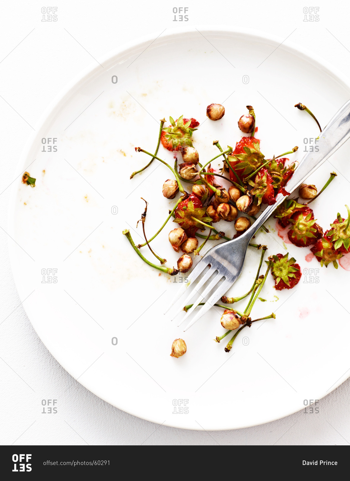 Cherry seeds and stems on plate
