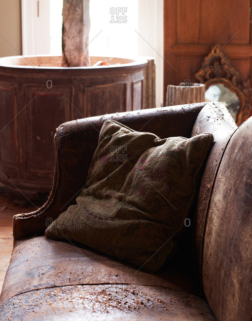 Vintage leather couch and textile pillow