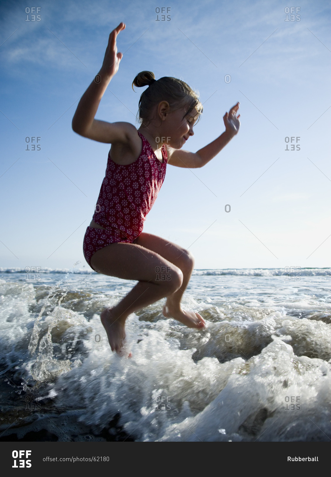 Young girl jumping in water
