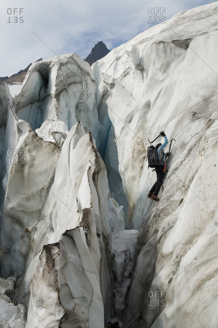 A woman ice climbing on a glacier, Mount Baker Wilderness, Bellingham, Washington