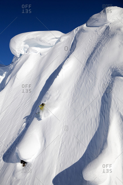 A male skier skis a big first descent in Haines, Alaska