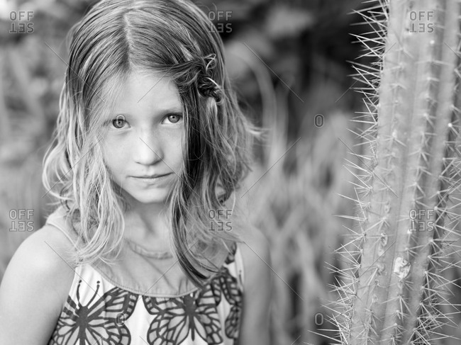 girl poses with cactus