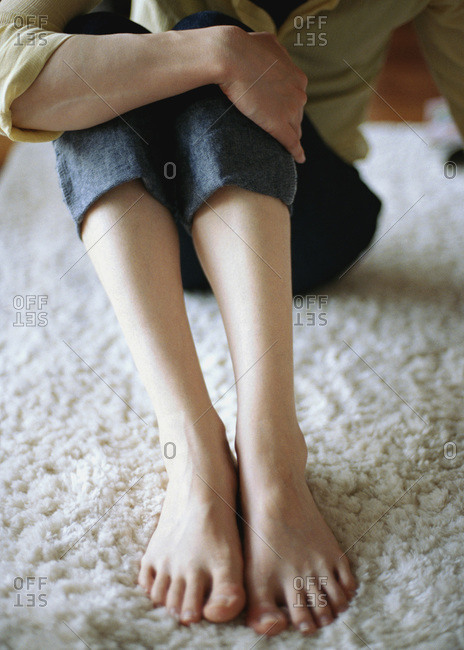 Feet of person on white carpet