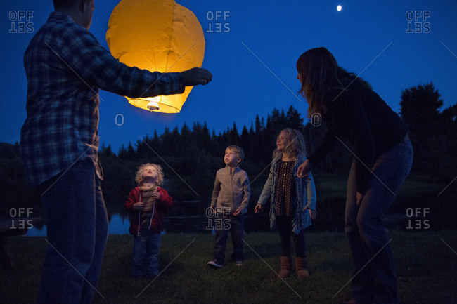 Parents showing sky lantern to their kids