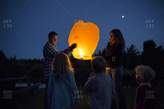 Parents showing sky lantern to their kids