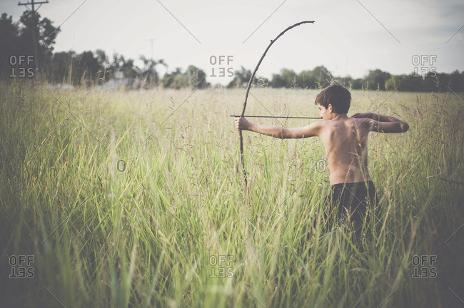 Side-view of boy practicing archery