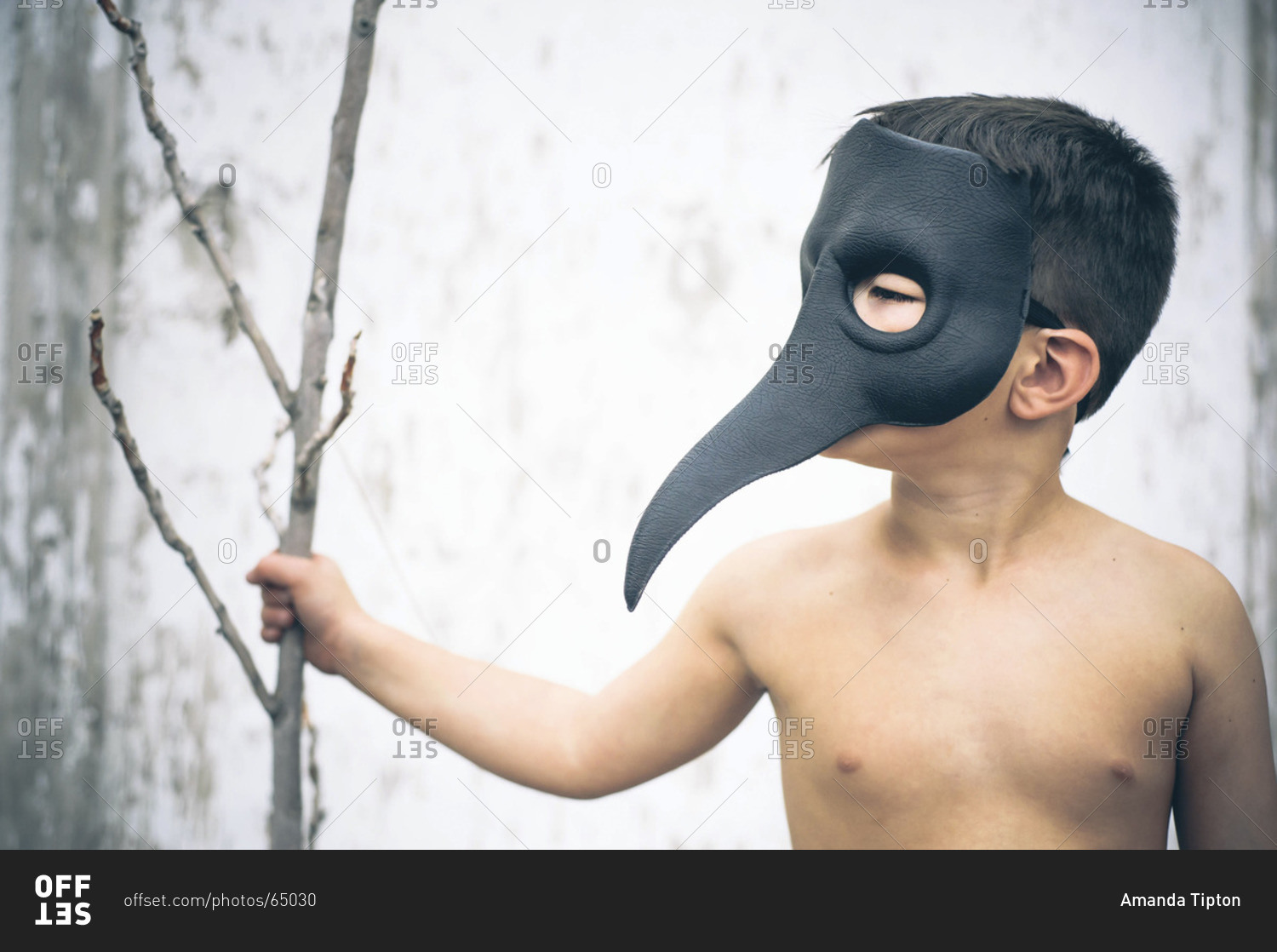 Boy wearing bird-like beak mask