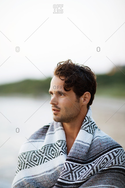 Portrait of a man covering himself with blanket
