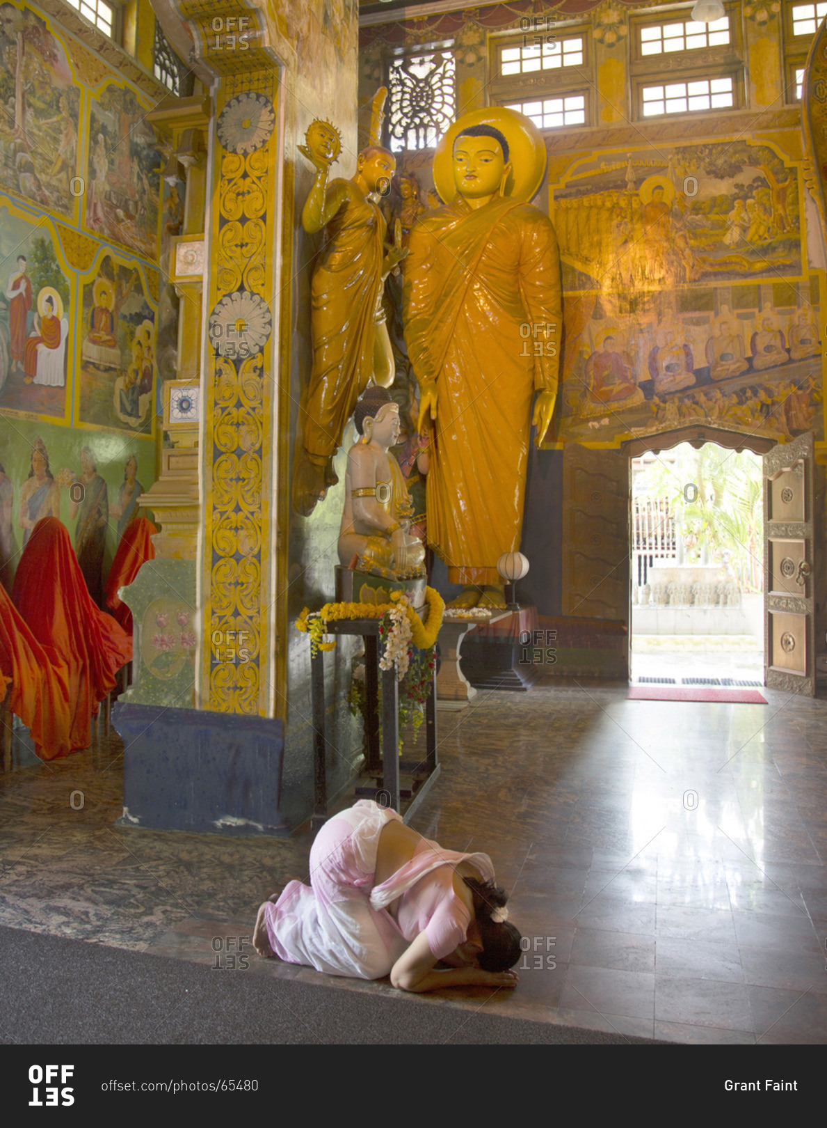Temple interior with prayer woman in Colombo, Sri Lanka