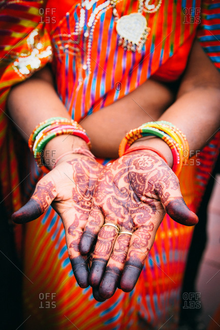Mid-section view of traditional Indian woman wearing Indian bracelets and henna painting in Agra, India