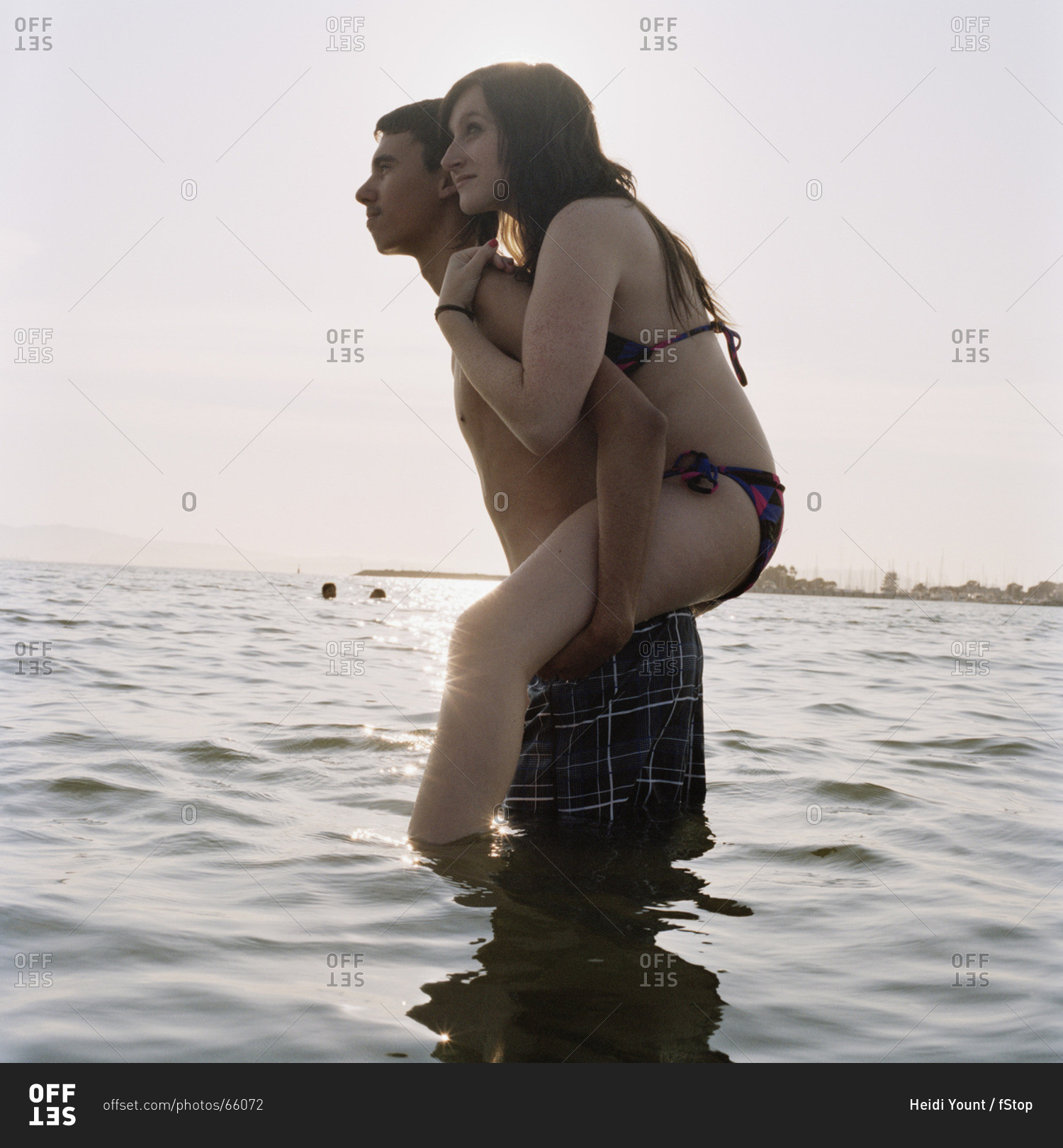 Young man giving his girlfriend a piggyback ride on the beach - a Royalty  Free Stock Photo from Photocase